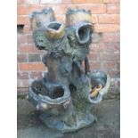 A 19TH CENTURY TREACLE GLAZE GARDEN PLANTER, modelled as a tree trunk with numerous pockets to the