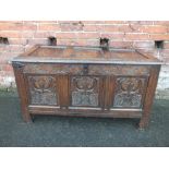 A 19TH CENTURY OAK CARVED COFFER, the lid with original hinges, candle drawer to the inside,