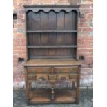 A SMALL REPRODUCTION OAK DRESSER POSSIBLY BY TITCHMARSH & GOODWIN, the panelled plate rack above a
