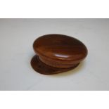 AN UNUSUAL TREEN SNUFF BOX IN THE FORM OF AN OFFICERS PEAKED CAP, W 9.5 cm