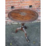 A 19TH CENTURY OAK CARVED TILT TOP PEDESTAL TABLE, the circular top with carved detail to the centre