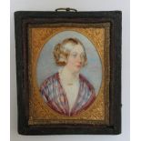 A LATE 19TH / EARLY 20TH CENTURY OVAL PORTRAIT MINIATURE OF A LADY IN A TARTAN SHAWL, in a leather