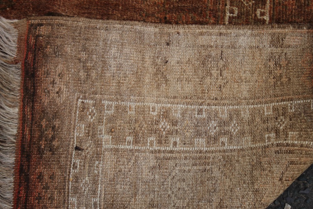 A BOKHARA STYLE WOOLLEN RUG, with an all over pattern on a mainly red ground, 137 x 208 cm - Faded - Image 6 of 6