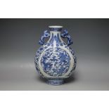 AN ORIENTAL TWIN HANDLED BLUE AND WHITE MOON VASE, having typical dragon decoration and six