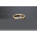 A HALLMARKED 9 CARAT GOLD CHANNEL SET DIAMOND RING, set with approx 0.25 ct diamonds, ring size R