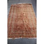 A BOKHARA STYLE WOOLLEN RUG, with an all over pattern on a mainly red ground, 137 x 208 cm - Faded