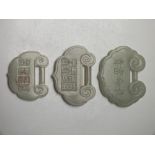 THREE CHINESE CELADON JADE LOCK PENDANTS, in graduating sizes, given as a token of long life, finely