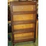 A WEIS FOUR SECTION GLAZED BOOK CASE, raised on shaped legs H 153 cm W 87 cm