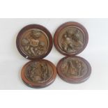 FOUR PRESSED COPPER ALLOY WALL PLAQUES, two depicting children (one signed Lyon) and two depicting