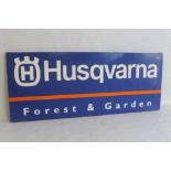 A VINTAGE "HUSQVARNA" METAL ADVERTISING SIGN in blue, orange & white, 125 x 50 cm