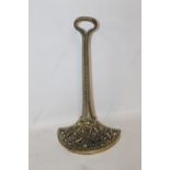 AN ANTIQUE BRASS DOOR STOP with weighted base, loop handle, H 37 cm