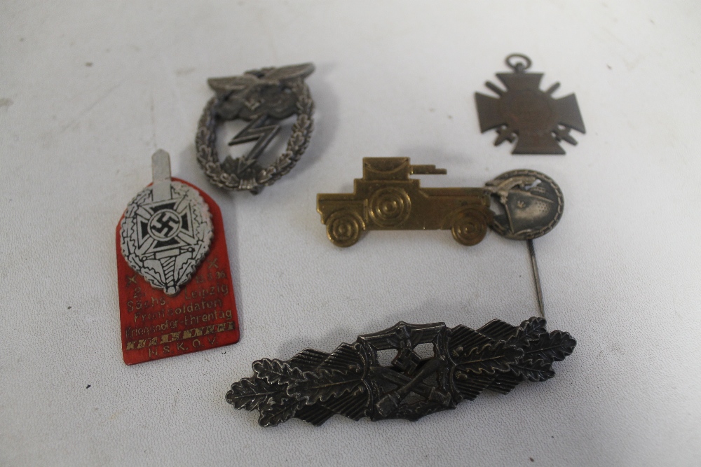 A COLLECTION OF GERMAN TYPE BADGES, to include a WWI honour cross with swords and a British Lancers