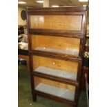 A WEIS FOUR SECTION GLAZED BOOK CASE, raised on shaped legs H 153 cm W 87 cm