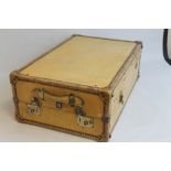 A VINTAGE VELLUM COVERED TRAVEL TRUNK, with fitted green cloth interior, maker tag for "Watajoy"