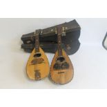 TWO VINTAGE BOW BACK MANDOLINS, both with inlaid decoration and both in carry cases (2)