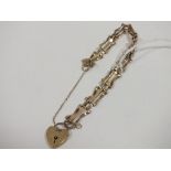 A LADIES 9CT GOLD GATE LINK BRACELET WITH HEART LOCK