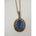 A 9CT GOLD PENDANT ON CHAIN SET WITH LARGE BLUE STONE