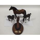 A BESWICK DARTMOOR PONY FIGURE TOGETHER WITH TWO FOALS AND A BUST OF RED RUM (4)