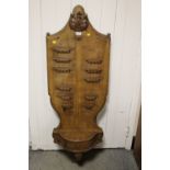 A LARGE WOODEN WALL HANGING PIPE RACK