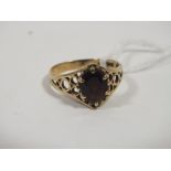 A LADIES 9CT GOLD AND GARNET DRESS RING