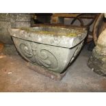 A SMALL SQUARE STONE PLANTER