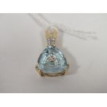 A HALLMARKED 9K GOLD TRILLIANT CUT SKY BLUE TOPAZ AND DIAMOND PENDANT