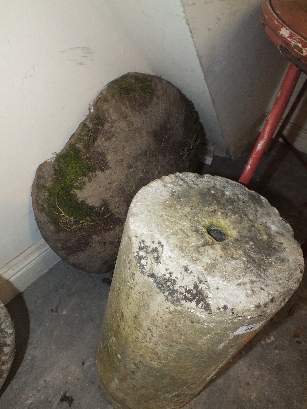 A LARGE STONE MUSHROOM TOP ON ROLLER BASE