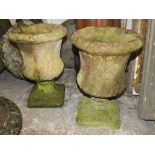 A PAIR OF STONE GARDEN PLANTERS WITH LEAF DETAIL