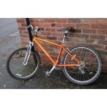 AN ORANGE RALEIGH BICYCLE