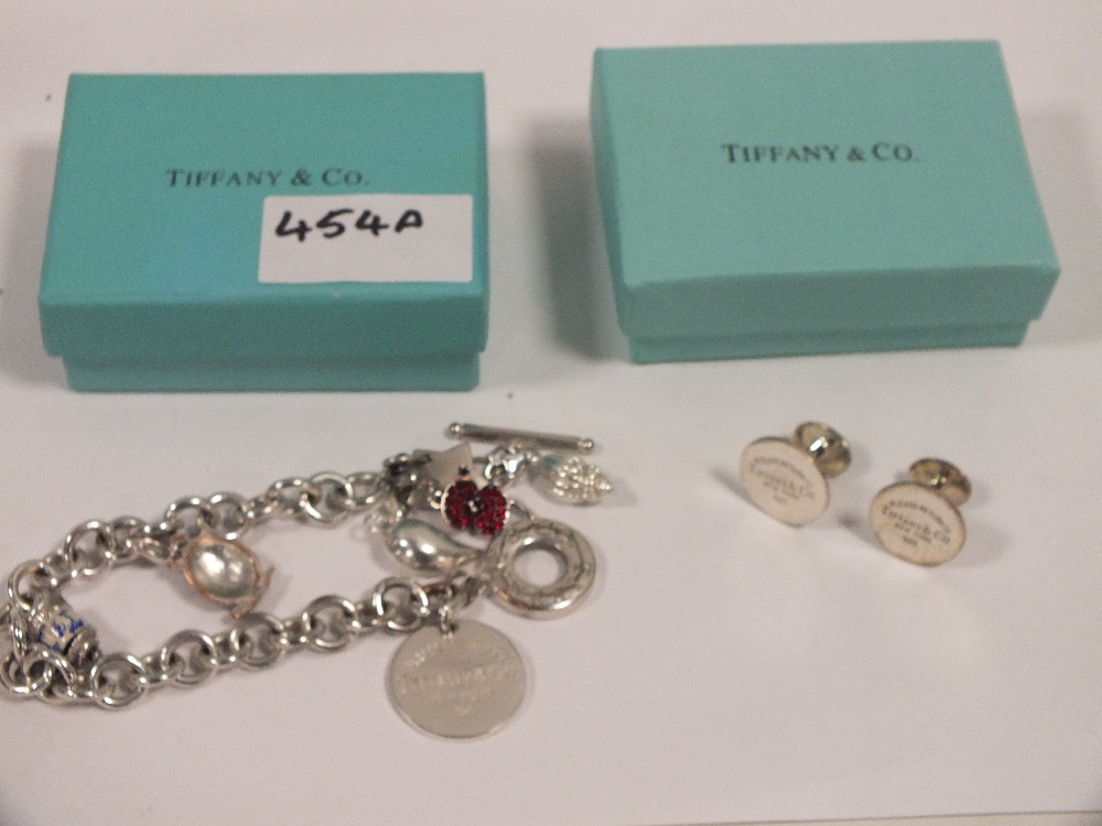 A BOXED TIFFANY AND CO STYLE CHARM BRACELET AND CUFFLINKS