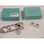 A BOXED TIFFANY AND CO STYLE CHARM BRACELET AND CUFFLINKS