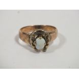 A LADIES EQUESTRIAN INTEREST HORSE SHOE AND OPAL RING