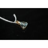 A HALLMARKED 9K GOLD TRILLIANT CUT SKY BLUE TOPAZ AND DIAMOND PENDANT