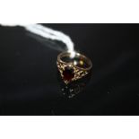 A LADIES 9CT GOLD AND GARNET DRESS RING