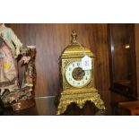 A 20TH CENTURY GILT METAL MANTEL CLOCK, of square form, the circular dial with Arabic numerals,