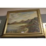 A FRAMED AND GLAZED OIL PAINTING DEPICTING A MOUNTAINOUS PATH SIGNED G.H. MOORE