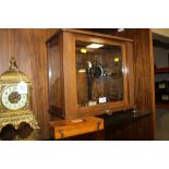 A SET OF BAIRD AND TATLOCK GLASS CASED VINTAGE SCALES AND WEIGHTS