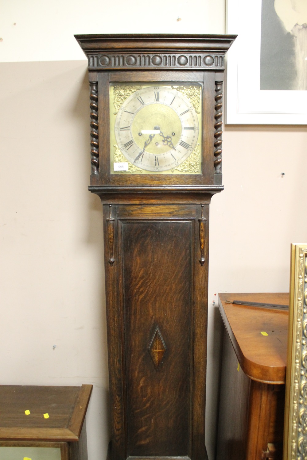 AN EARLY 20TH CENTURY OAK LONGCASE CLOCK WITH BARLEYTWIST DETAIL