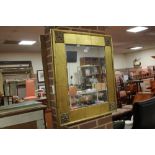 A MODERN GILT FRAMED MIRROR