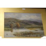 A FRAMED AND GLAZED WATERCOLOUR DEPICTING A COUNTRY RIVER SCENE WITH CATTLE AND BIRDS SIGNED W.