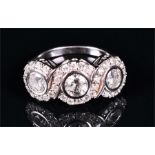 An 18ct white gold and diamond triple cluster ring collet set with three round brilliant-cut