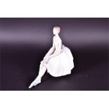 A boxed Lladro Utopia figure of a seated ballerina holding a single rose upon her lap, 26 cm high.