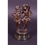 A charming late 19th century bronze of two dancing children with clothes billowing in the wind,