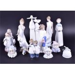 A collection of Lladro and Nao figure groups to include a tall group of two Lladro nuns, 33 cm high,