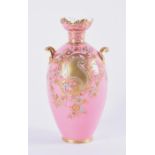 A pink ground Derby vase of baluster form, handles to shoulders, with gilt scrolled and floral