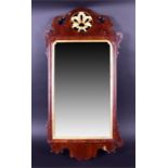 A Georgian walnut and gilt pier mirror the shaped frame with pierced and gilded roundel to the