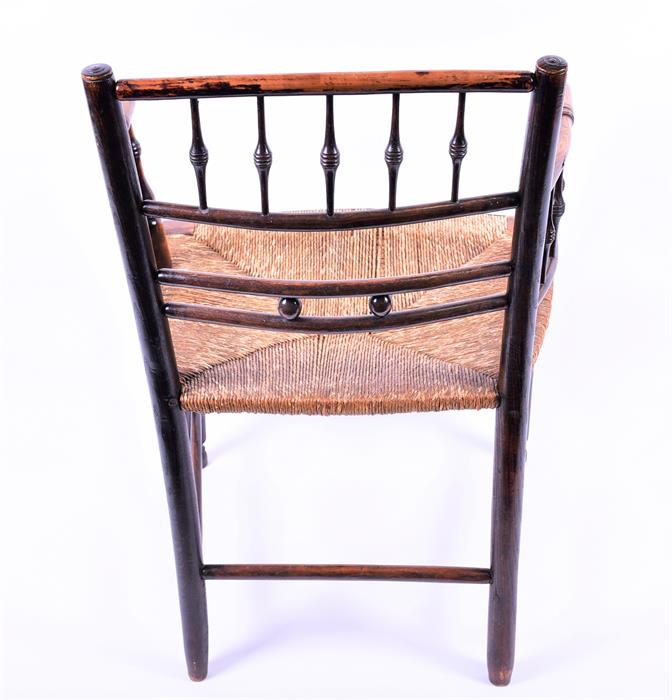 A Victorian oak and stained beech William Morris Sussex chair with rush seat and turned supports, - Image 3 of 5