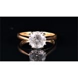 An 18ct yellow gold and solitaire diamond ring set with a round brilliant-cut stone of approximately