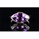 A 9ct white gold, diamond, and amethyst ring set with a horizontal-set faceted marquise-cut