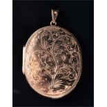 A 9ct yellow gold locket of oval form, the hinged front with engraved floral decoration, opening